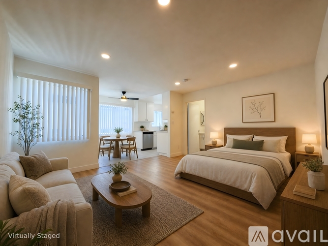 A bedroom with a large bed and a couch.