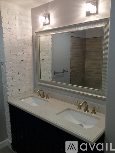 A bathroom with a white sink and a mirror above it.