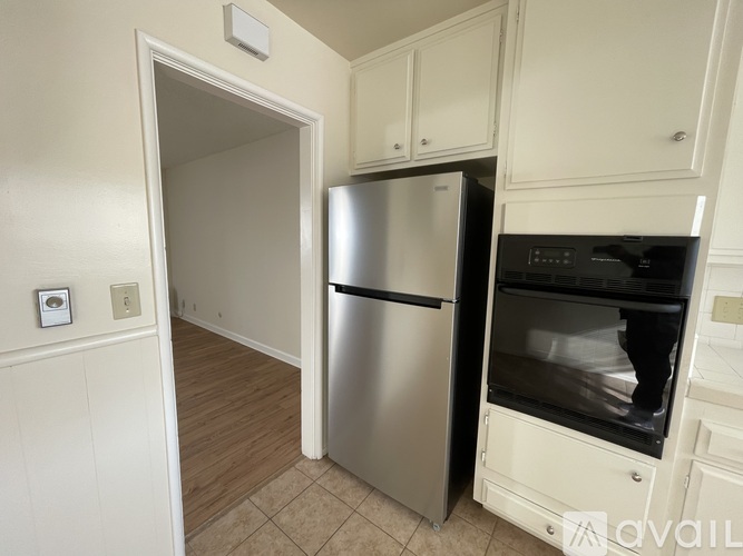 A kitchen with a stainless steel refrigerator and oven.