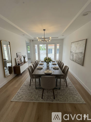 A dining room with a long table set for a meal.