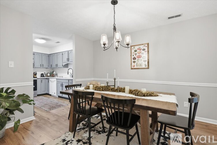 A dining room with a table set for a meal.