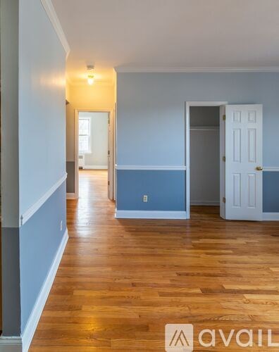 A room with wooden floors and two doors.