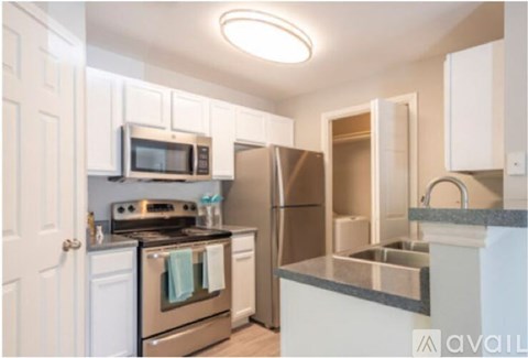 A kitchen with white cabinets and stainless steel appliances.