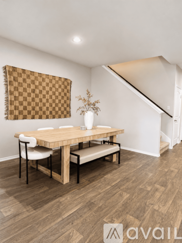 A dining room with a wooden table and chairs.
