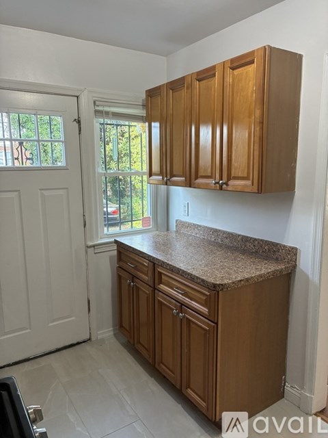 A kitchen with wooden cabinets and a granite countertop.