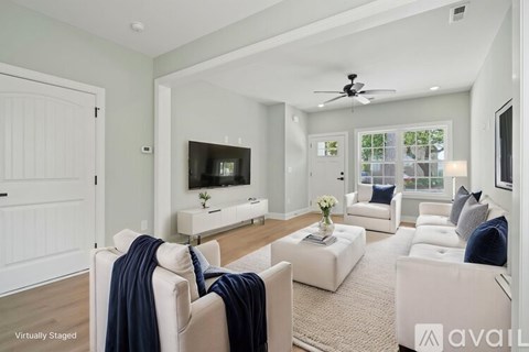 A living room with a white couch and a television.