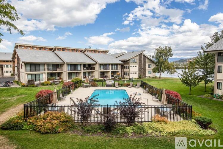A large building with a pool in front of it.