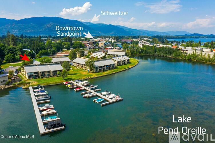 A lake with boats and a building with a red arrow pointing to it.