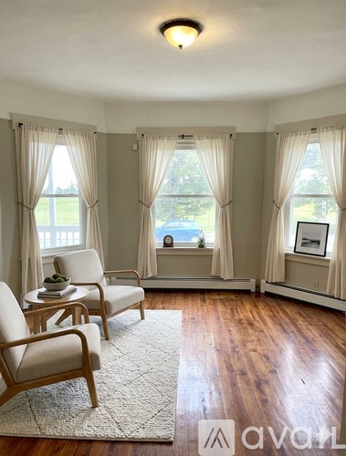 A living room with two chairs and a table.