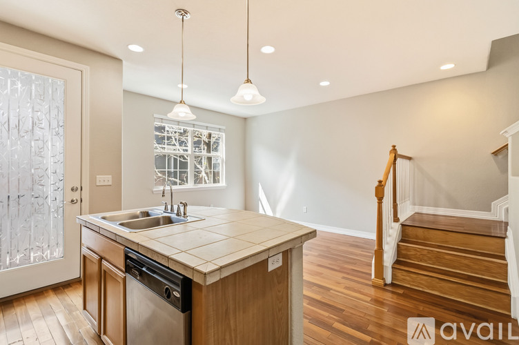 A kitchen with a wooden island and stainless steel appliances.