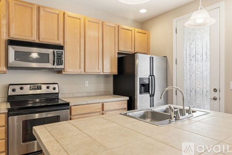A kitchen with wooden cabinets and stainless steel appliances.