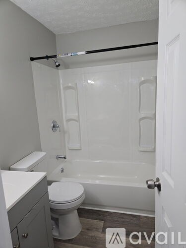 A bathroom with a toilet, sink, and bathtub.
