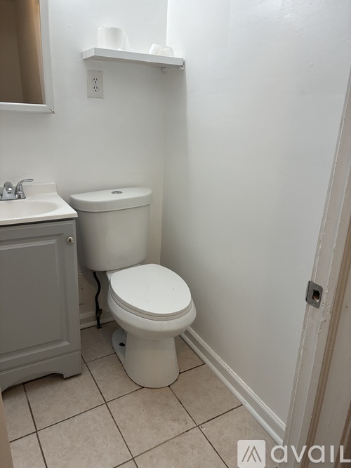 A white toilet and sink in a small bathroom.