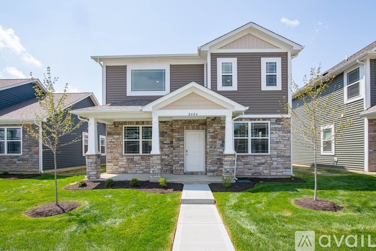 A house with a front yard and a walkway leading to the front door.