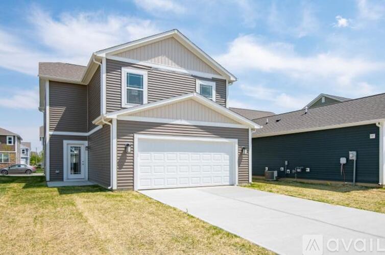 A two-story house with a garage is available for sale.