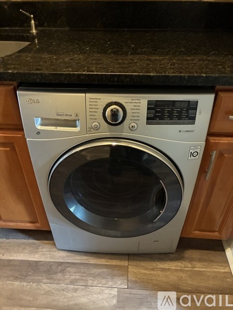 A front-loading LG washing machine in a kitchen.
