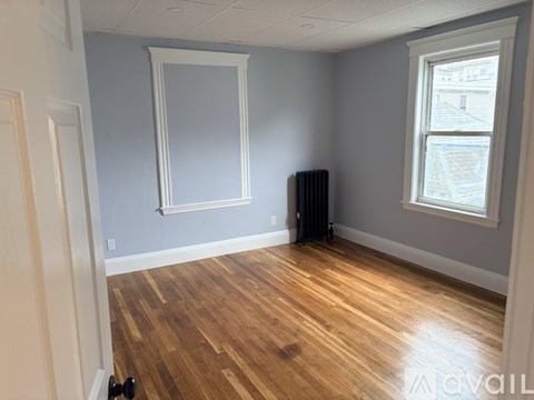 A room with wooden floors and a window.