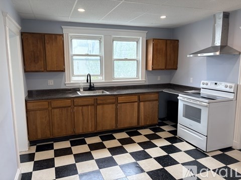A kitchen with black and white checkered floor.