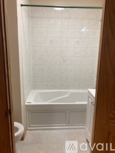 A white bathroom with a glass shower door.