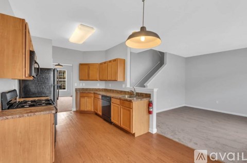 A kitchen with wooden cabinets and a stove top oven.