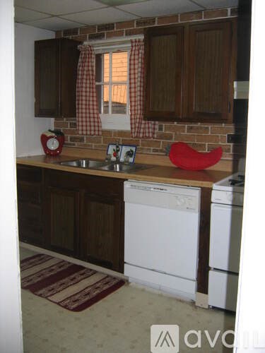 A kitchen with a white washer and dryer.