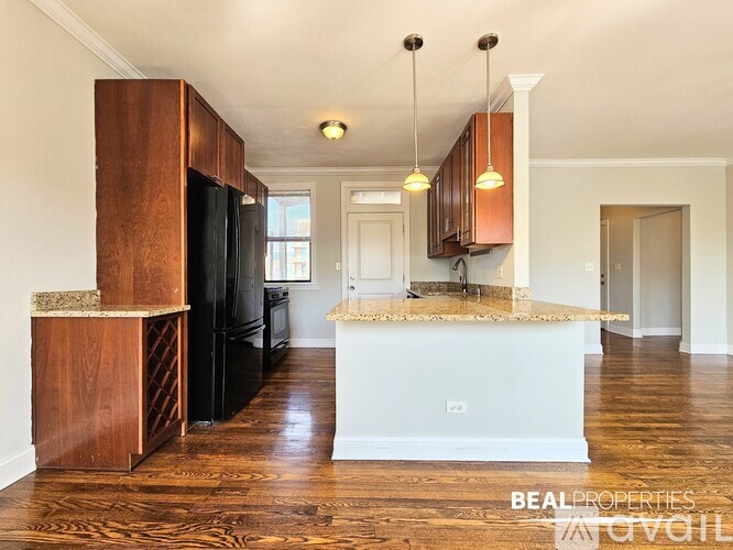 A kitchen with a white island and wooden cabinets.