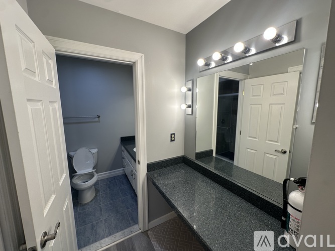 A spacious room with a staircase and exposed ceiling beams.