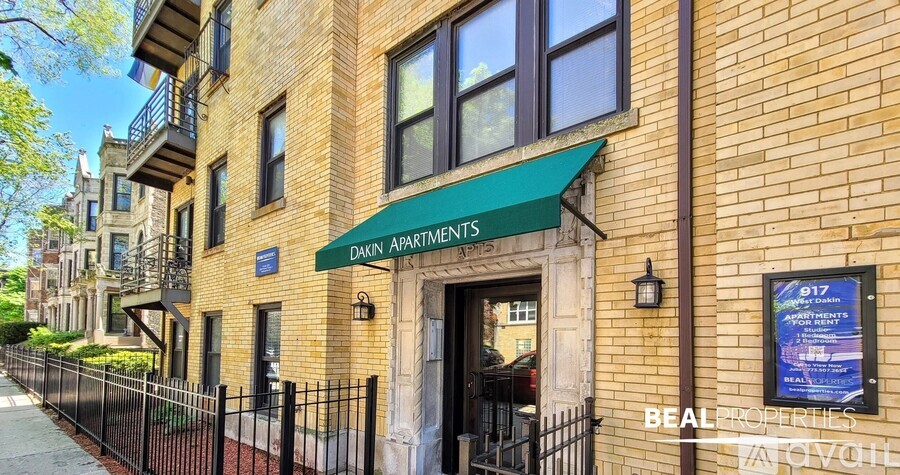A building with a green awning and a sign that says "DAKIN APARTMENTS" is shown.