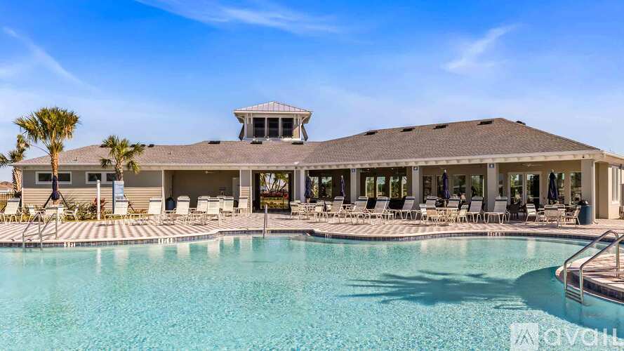A large house with a pool in front of it.