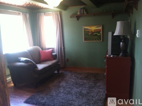 A living room with a couch and a lamp.