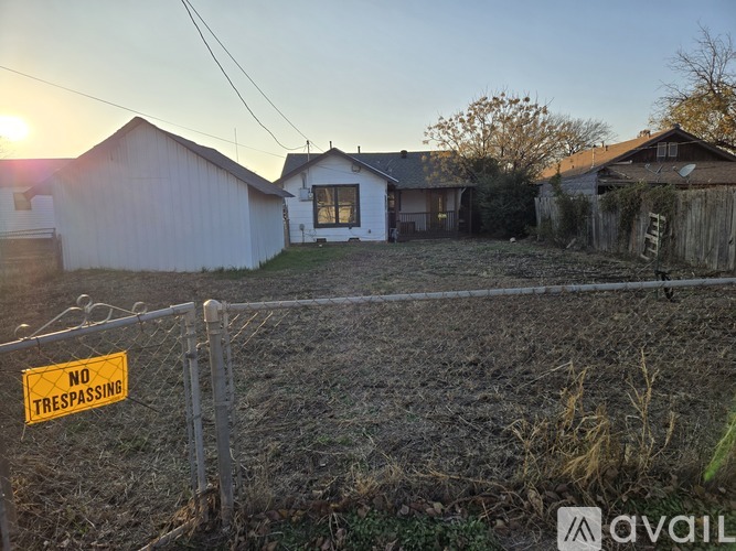 A fenced area with a sign that says "NO TRESPASSING".