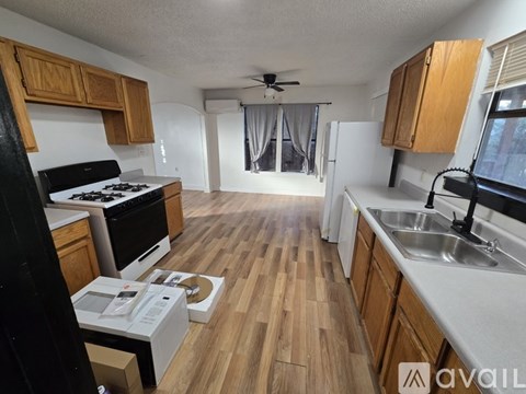 A kitchen with wooden cabinets and a white countertop.