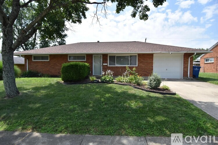 A house with a tree in front of it.