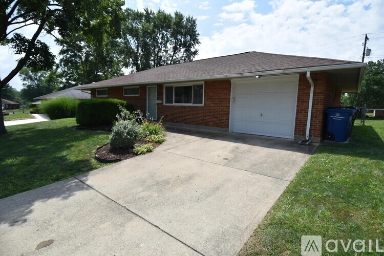 A house with a garage and a driveway in front.