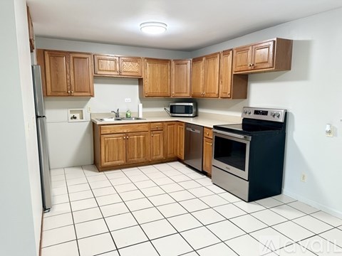 A kitchen with wooden cabinets and a black oven.