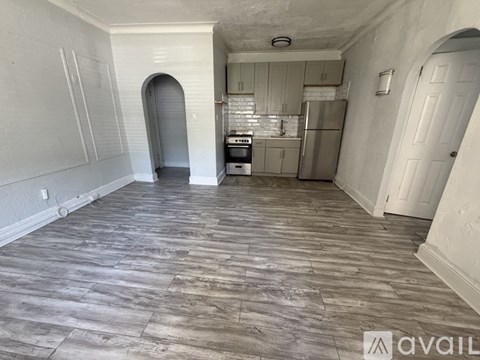 A kitchen with a refrigerator, oven, and sink is available for rent.