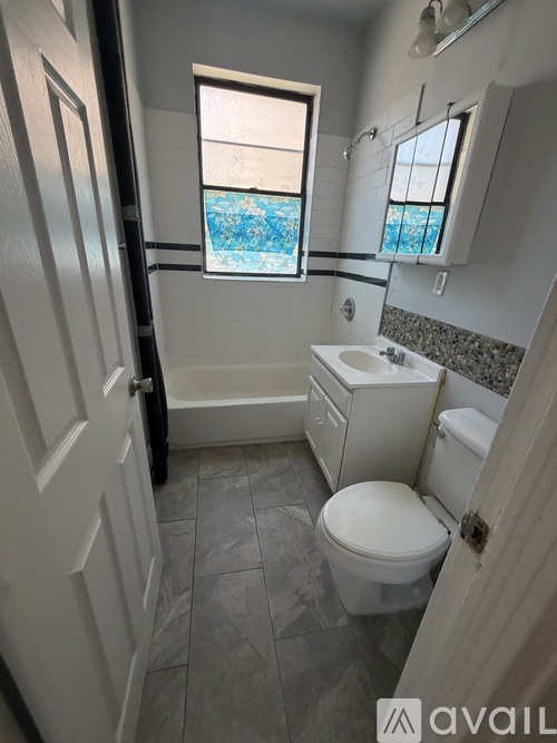 A bathroom with a toilet, sink, and bathtub.