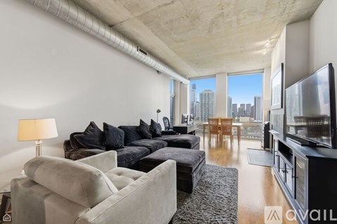A living room with a grey couch and a television.