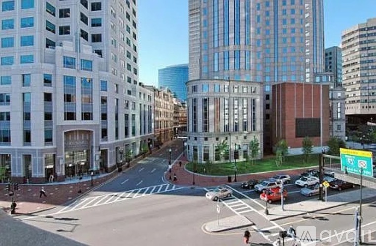 A city street with cars and buildings.