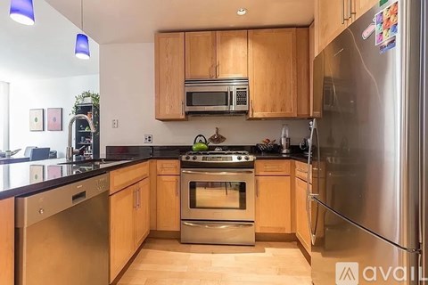 A kitchen with wooden cabinets and stainless steel appliances.
