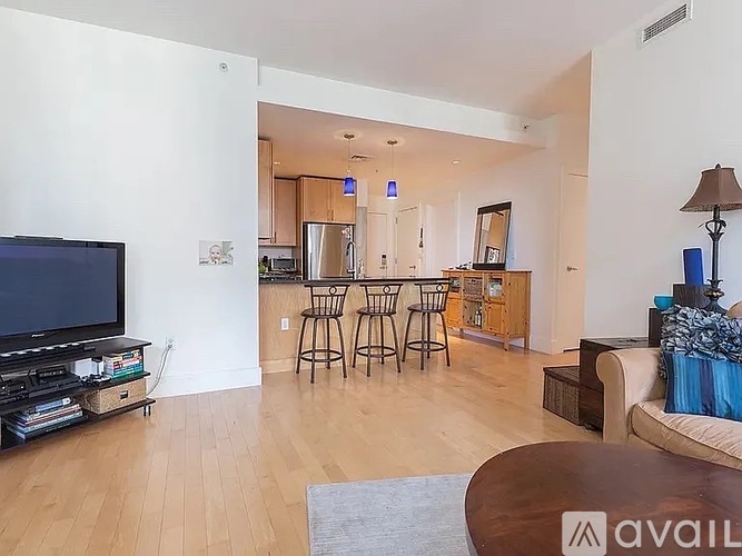 A living room with a television, a couch, and a coffee table.