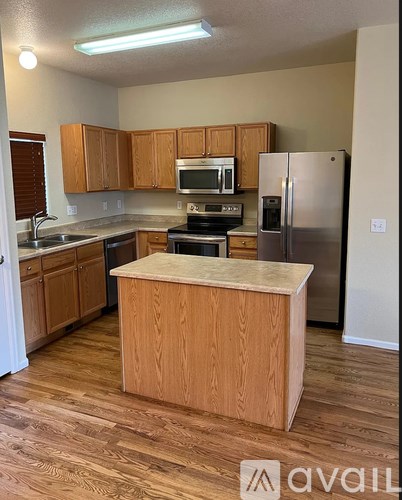 A kitchen with wooden cabinets and a central island.