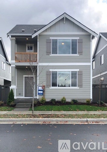 A two-story house with a balcony on the second floor.