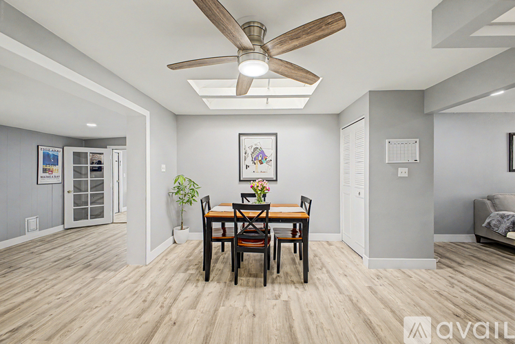 A dining room with a wooden table and chairs.