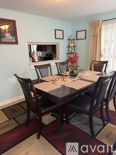 A dining room with a table set for four.