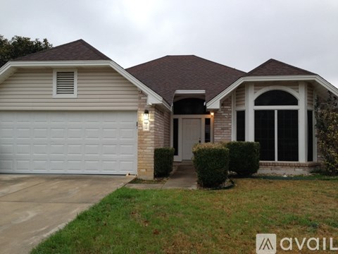 A house with a garage and a driveway.