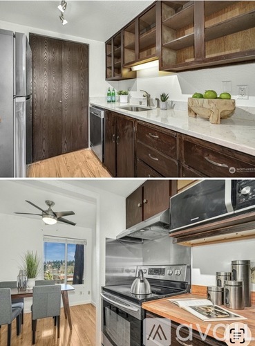 A modern kitchen with dark wood cabinets and stainless steel appliances.