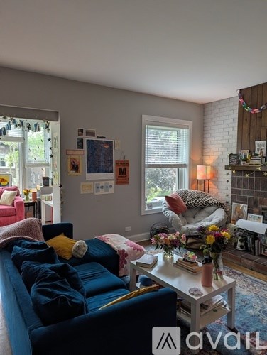A living room with a blue couch and a white coffee table.