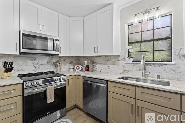 A kitchen with a stove top oven and a microwave above it.