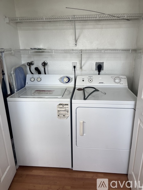 A white washer and dryer in a small laundry room.